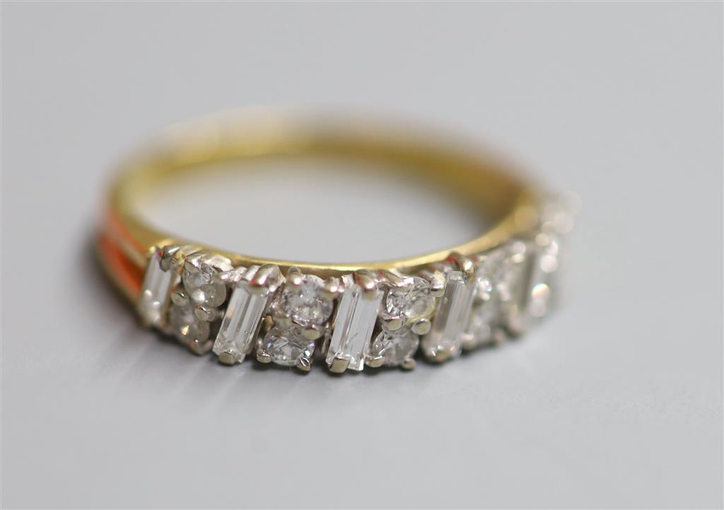 A modern 18ct gold, fives stone baguette and ten stone round cut diamond cluster set half hoop ring, size M, gross 2.8 grams,